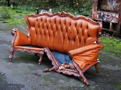 Company skip hire vehicle parked on street with safety cones