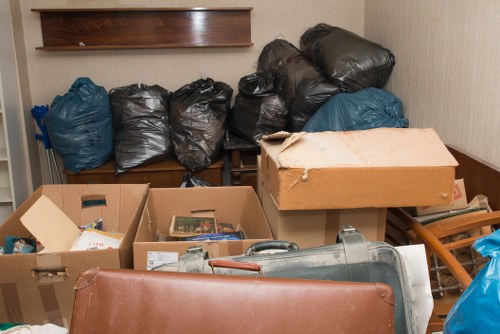 Customers loading waste into a skip container